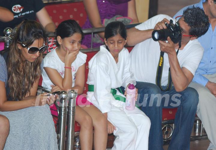 Shahrukh Khan takes photo of wife Gauri Khan while daughter Suhana looks on during the 6th National Taekwondo Competition 2010 Juniors & Sub Juniors