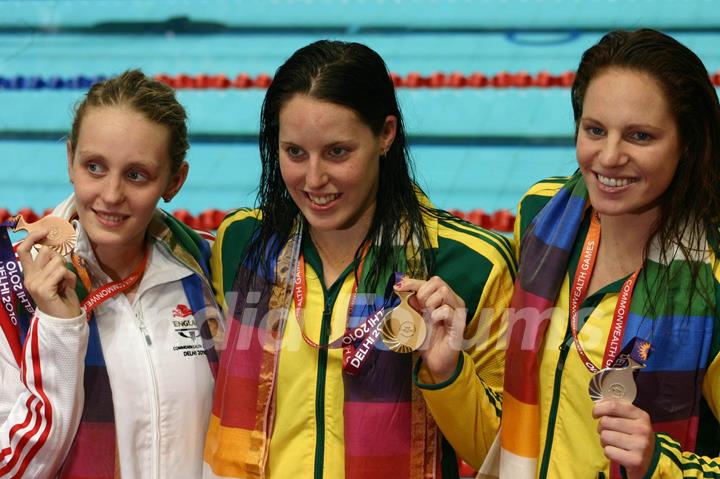 Australian Alica Jayne(Gold) and Emily Jane(Silver) with England,s Francesca Jeanafter(Bronze) , in the Swimming Women 100m Freestyle event at the 19 Commonwealth Games in New Delhi