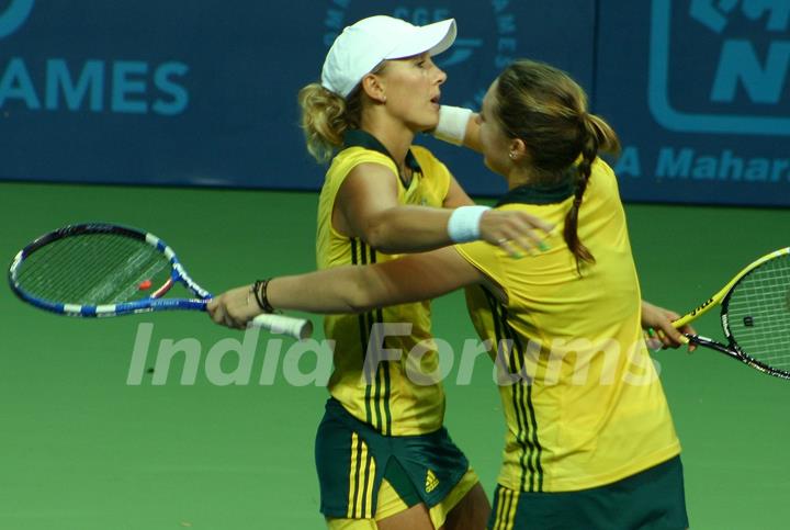 Australia's Anastasia Rodionova  and Sally Peers  after winning the gold over compatriots Olivia Rogowska and Jessica Moore during the final match for the women's doubles gold medal at the 19th Commonwealth Games,in New Delhi