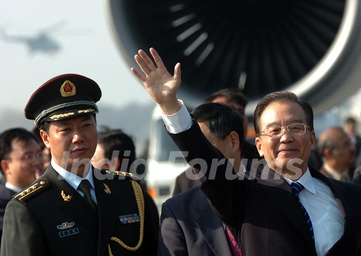 Chinese Premier Wen Jiabao waves as he arrives for a three-day visit to India, in New Delhi, India, Wednesday, Dec. 15, 2010. Wen arrived Wednesday as part of efforts to build trust between the rival neighbors amid lingering disputes over ...