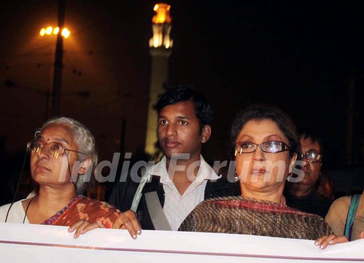 Eminent Tollywood actress Aparna Sen (R) famous social activist Medha Pathekar takes part in a protest rally to free Dr. Binayak Sen from jail in Kolkata on Monday late night. .