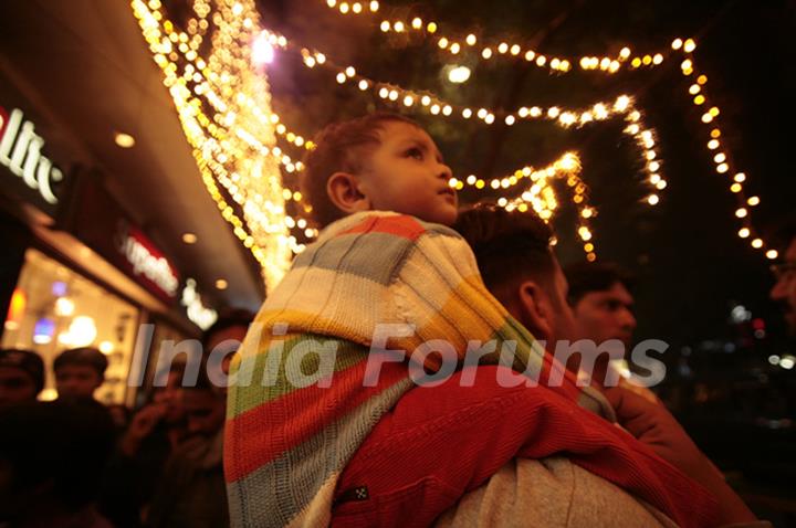 Kolkata: A child enjoys the ride of his father's soulder during the eve of up coming New Year 2011 in Kolkata on Wednesday. .