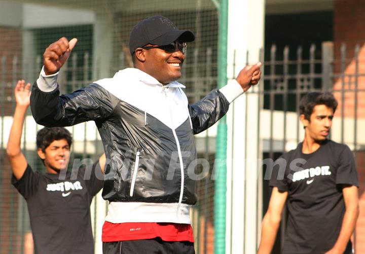 West Indies cricketer Brian Lara gives tips to young cricketers at Ferozshah Kotla  stadium in New Delhi on Tuesday. .