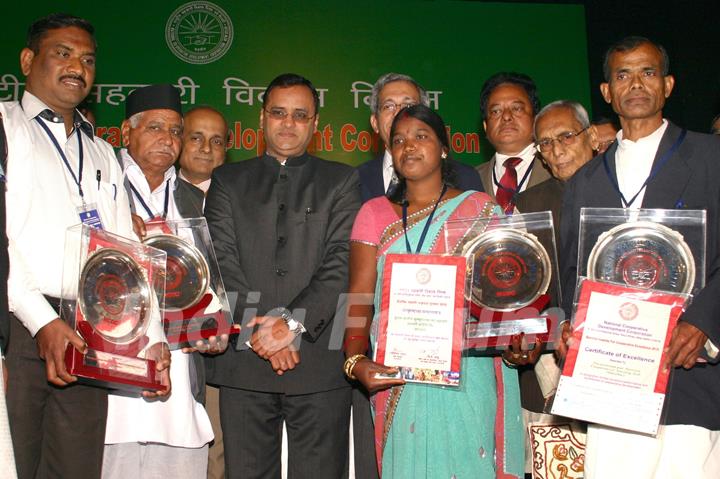 Minister of State for Agriculture and Food Processing Industries, Arun Yadav with the NCDC Biennial awardess at a function, in New Delhi on Friday. .