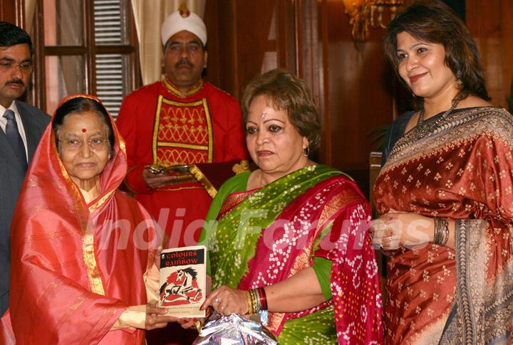 President Pratibha Patil receiving the first copy of the book ''Colours of My Rainbow'' from vice Presidents wife Salma Ansari at Rashtrapati Bhavan, on Monday. .