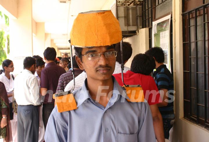 A IIT Delhi student with his innovated Head Load Transmitter at the Open House 2011 in New Delhi on Saturday. .
