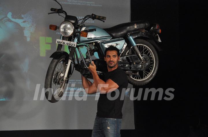 John Abraham holds up bike during the promotion of their film 'Force' in Mumbai