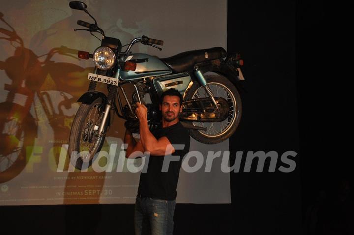 John Abraham holds up bike during the promotion of their film 'Force' in Mumbai