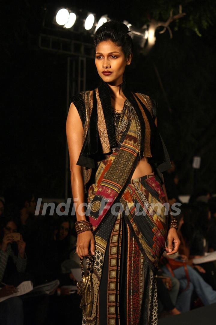 A model displays a creation by designer Tarun Tahiliani at the Wills Lifestyle India Fashion week 2012,in New Delhi on Thursday. .