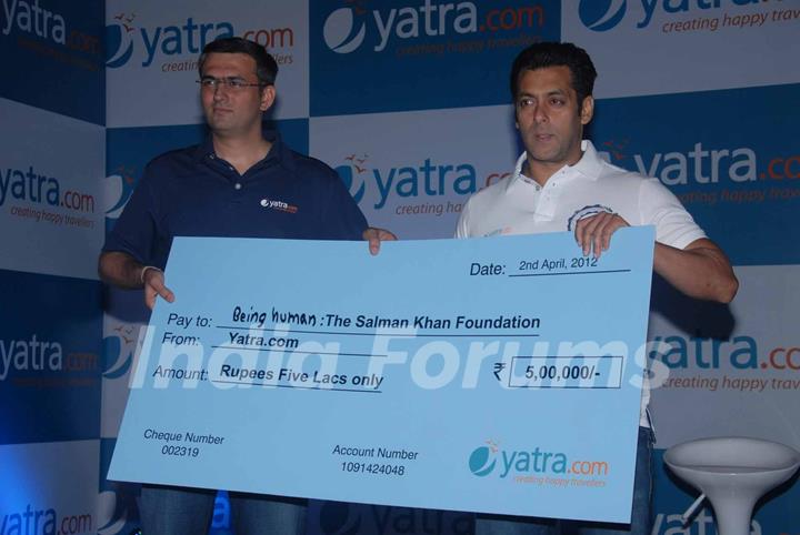 Yatra.com CEO, Mr Dhruv Shringi, presented a token amount of Rs. 5 Lakh to Salman for Being Human at Yatra.com new brand campaign launch press conference in Mumbai. .