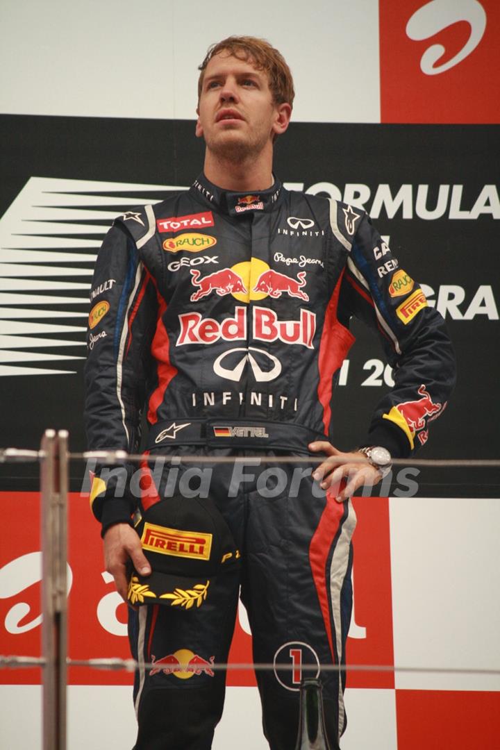 Red Bull Formula One driver Sebastian Vettel of Germany celebrates on podium after winning the Indian F1 Grand Prix