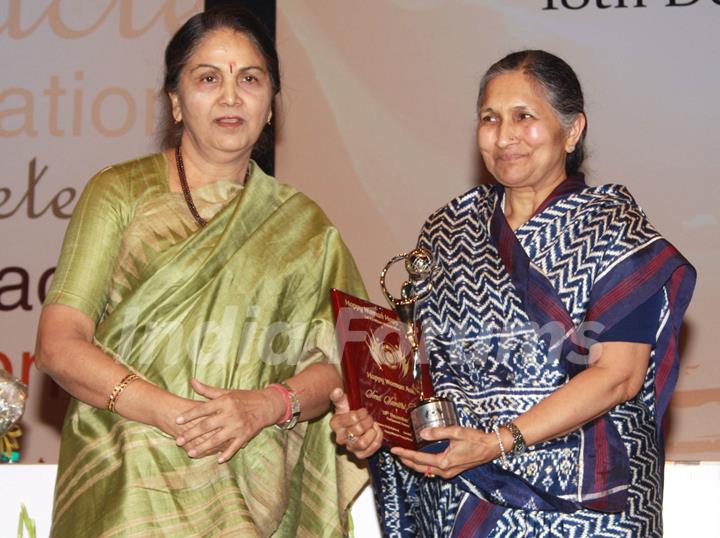 Naveen Jindal's mother Savitri Jindal receiving award from Justice Gyan Sudha Misra on &quot;Happy Woman's Day&quot; celebration at Balayogi Auditorium at Parliament House in New Delhi. (Photo: IANS/Amlan)