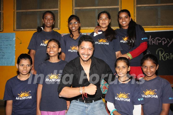 Shreyas Talpade shows off his Rakhis with his Rakhi sisters at the NGO