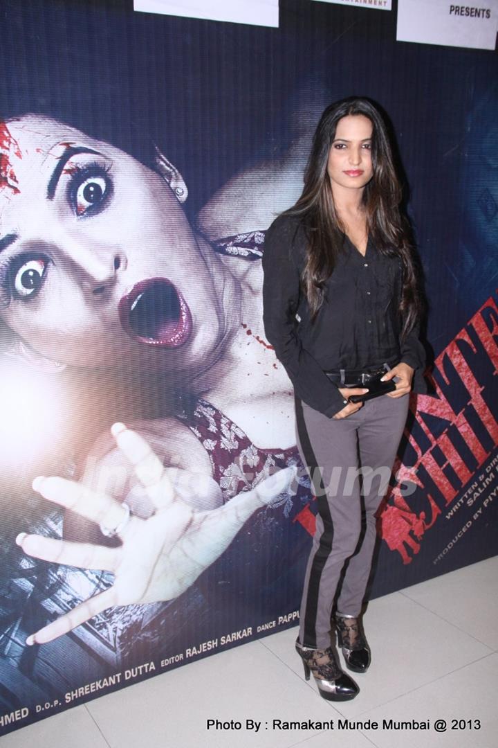 Piyu Chouhan poses alongside Haunted Child's poster