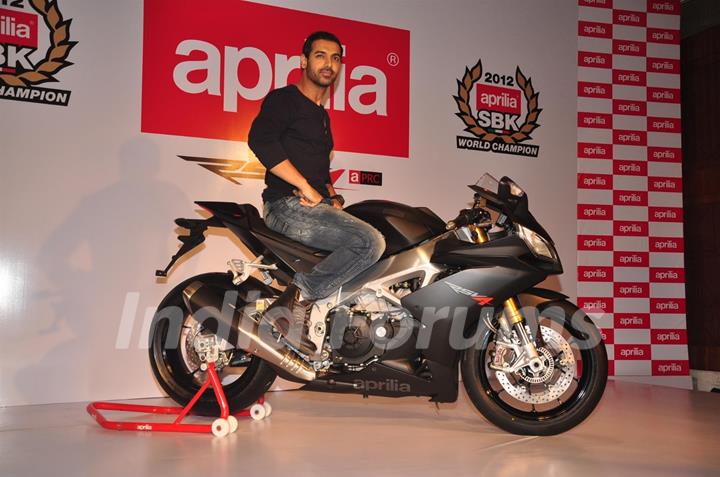 John Abraham poses with his new super bike Aprilia RSV4