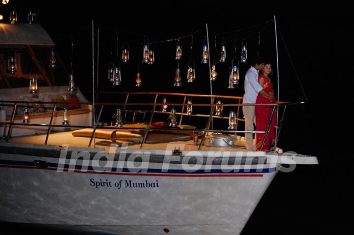 Raja Yudhishtir and Rani standing on a boat