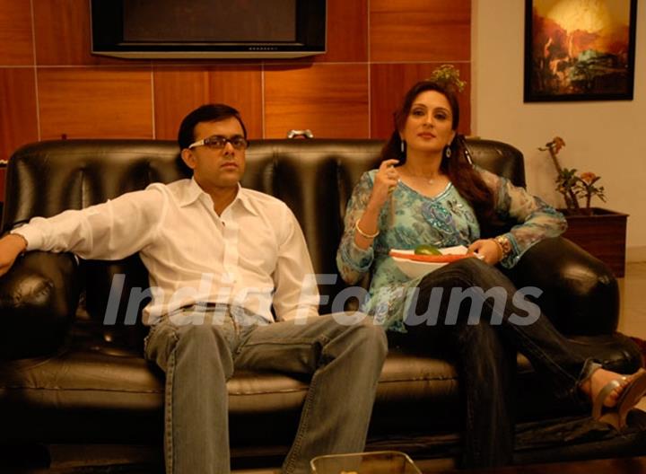 Radhika and Rajdeep sitting on a sofa