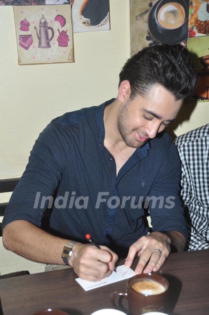 Imran Khan signs an autograph at the event