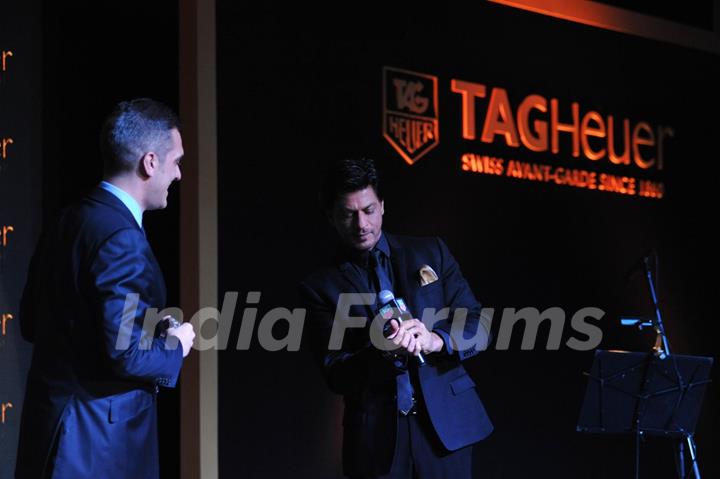 Shahrukh Khan tries on a watch at The Golden Era of the Carrera event by TAG Heuer