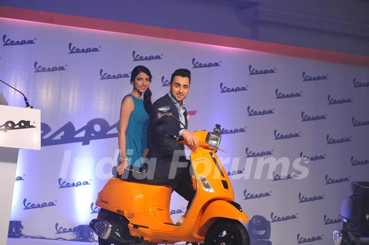 Imran Khan poses on the Vespa S with a fan