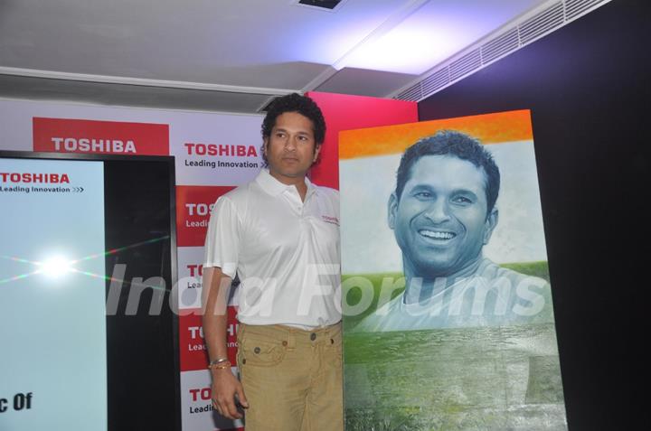 Sachin Tendulkar poses with his portrait at the launch 'WeAreSachin' campaign