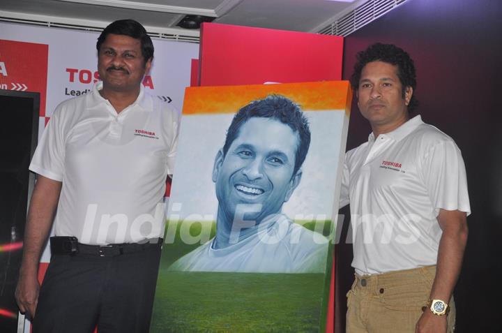 Sachin Tendulkar poses with his portrait at the launch 'WeAreSachin' campaign