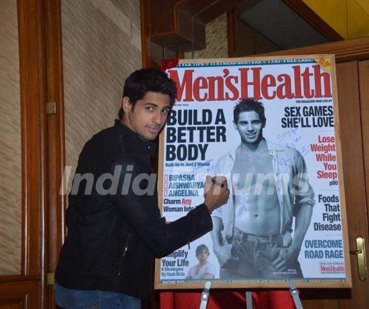 Sidharth Malhotra signs the Men's Health cover