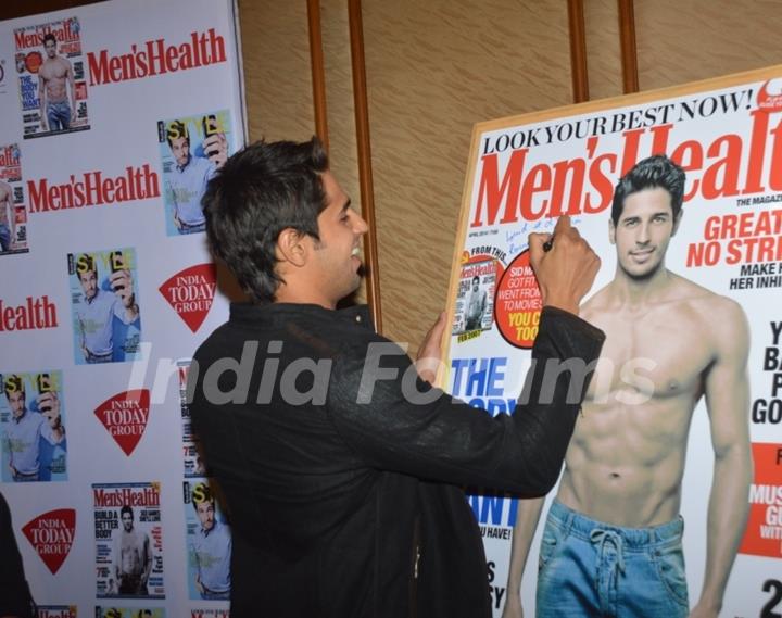 Sidharth Malhotra signs the Men's Health cover