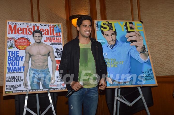 Sidharth Malhotra poses alongsidethe cover of Men's Health and Style