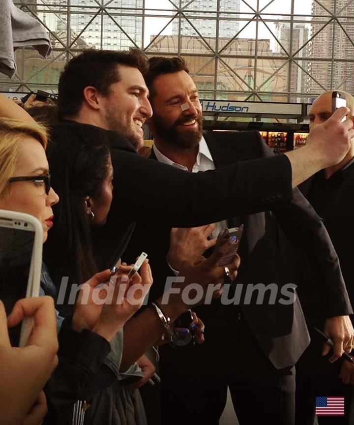 Hugh Jackman poses for a selfie with his fan at the Premiere