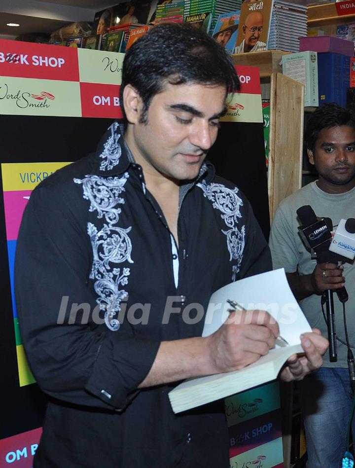 Arbaaz Khan autographs the book Yes Thank You Universe