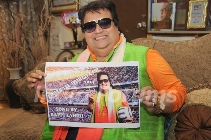 Bappi Lahiri shows the poster of 'Life of Football', his Latest single