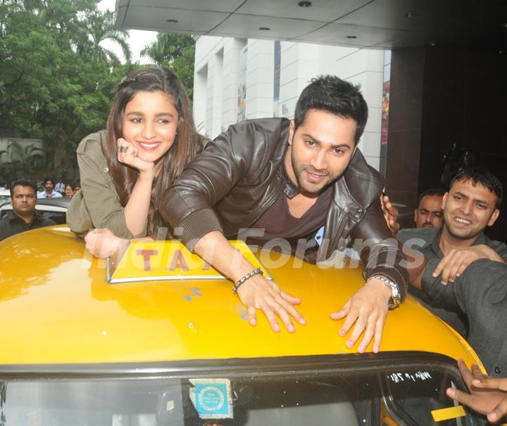 Varun Dhawan and Alia Bhatt take a ride on top of a cab at Kolkata