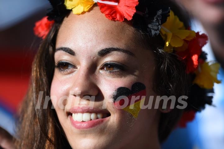 A fan paints the German flag on face