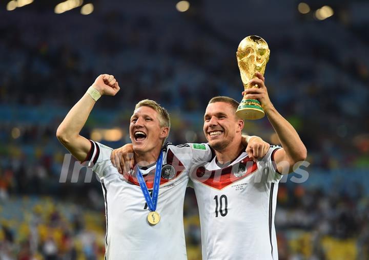 Bastain schweinsteiger and Podolski with the Trophy