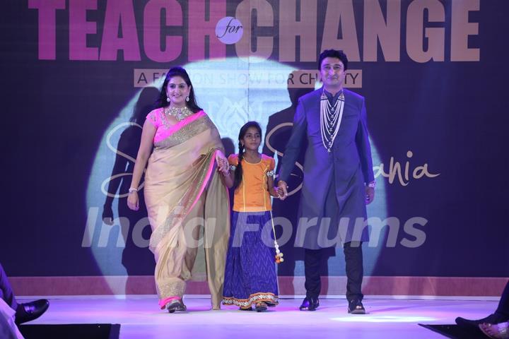 Guests with a child walk the ramp at the Teach for Change 2014 Fashion Show