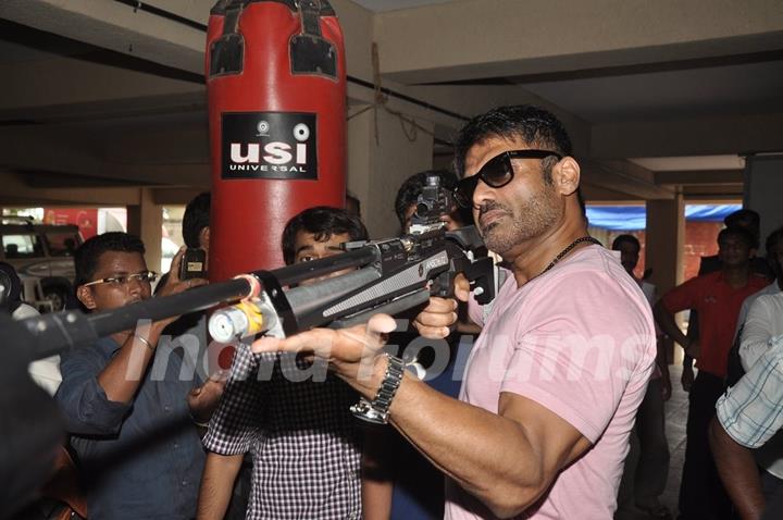 Suniel Shetty plays a shooting game at the Promotions of Desi Kattey