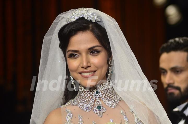 A model walks the ramp as a Christian bride at the IIJW 2014 - Day 2