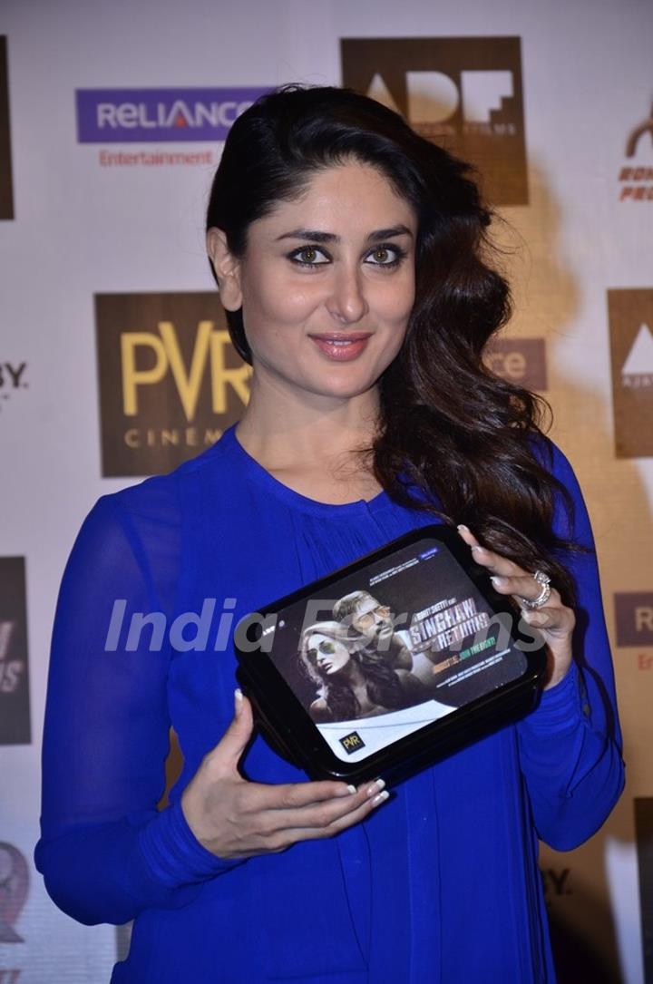 Kareena Kapoor holds a Singham Returns Merchandise at the Launch