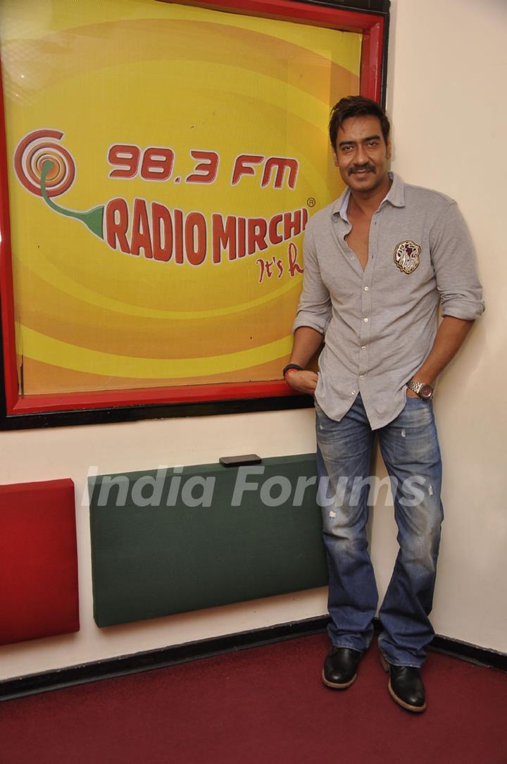 Ajay Devgn poses for the media at Radio Mirchi Studio