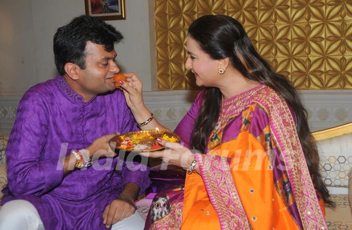 Poonam Dhillon gives her brother some sweets for Raksha Bandhan