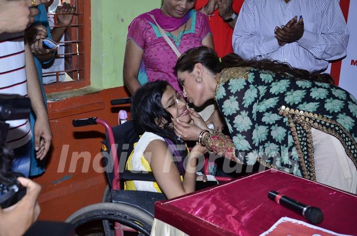 Rani Mukherjee was seen kissing a special child at the Promotion of Mardaani at a Local School