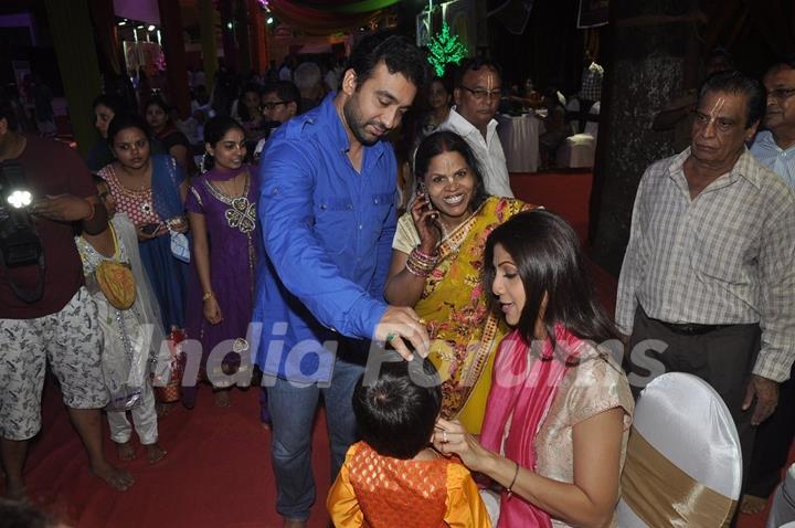 Raj Kundra puts a tilak to his son at Isckon Temple on Janmashtami