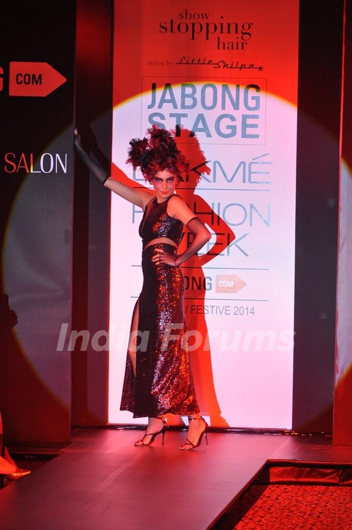 A model showcases a hair style by Little Shilpa at the Lakme Fashion Week Winter/ Festive 2014 Day 4