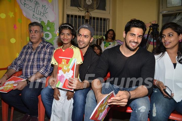 Varun Dhawan and Sidharth Malhotra pose with a kid at Ashray Ngo