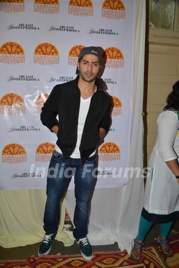 Varun Dhawan poses for the media at Ashray Ngo