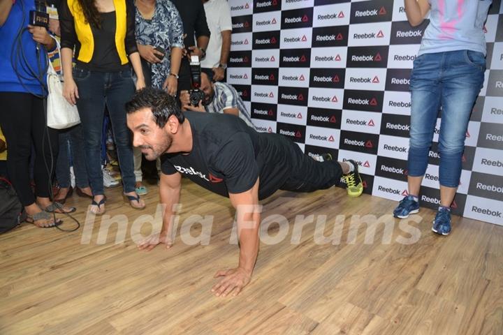 John Abraham does a push up exercise at the Press Meet of Reebok