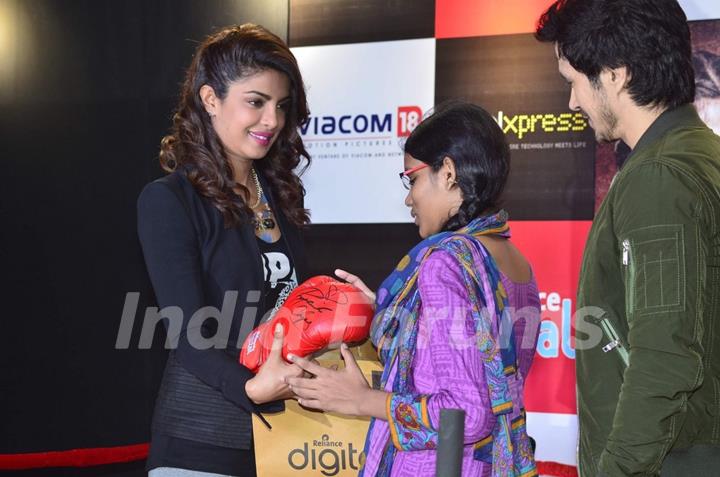 Priyanka Chopra gifts a boxing glove to a fan at the Promotions of Mary Kom at Reliance Outlet