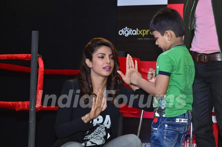 Priyanka Chopra teaches a young fan some boxing moves at the Promotions of Mary Kom