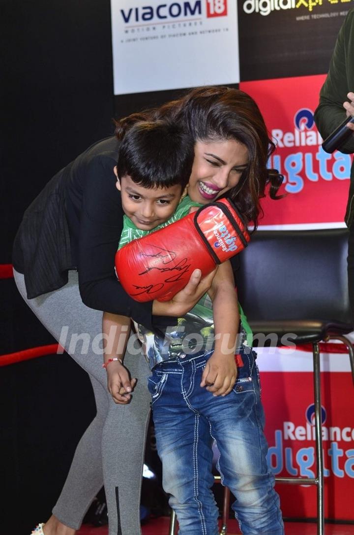 Priyanka Chopra hugs a young fan at the Promotions of Mary Kom